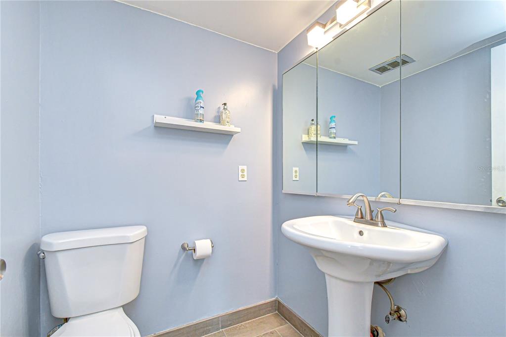 13402 Pinelake Way, Unit 202B Tampa, FL 33618 - Photo 28 of 42 a bathroom with a toilet sink and mirror