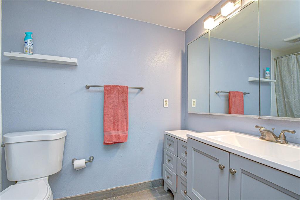 13402 Pinelake Way, Unit 202B Tampa, FL 33618 - Photo 32 of 42 a bathroom with a toilet sink and mirror
