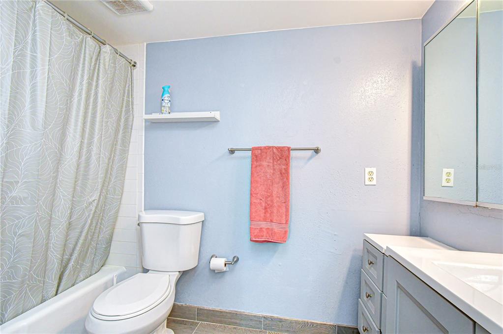 13402 Pinelake Way, Unit 202B Tampa, FL 33618 - Photo 33 of 42 a bathroom with a granite countertop toilet and a sink