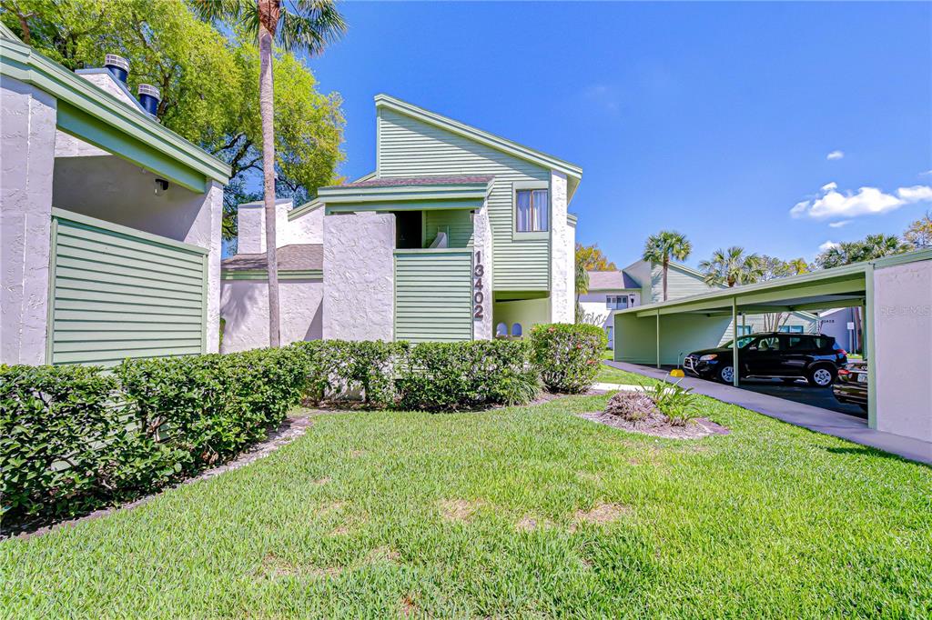 13402 Pinelake Way, Unit 202B Tampa, FL 33618 - Photo 34 of 42 a view of a house with a porch and furniture