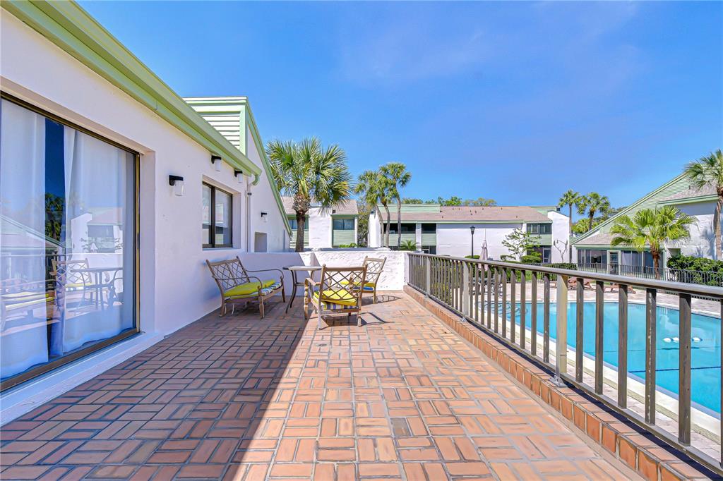 13402 Pinelake Way, Unit 202B Tampa, FL 33618 - Photo 39 of 42 a balcony with furniture and a potted plant