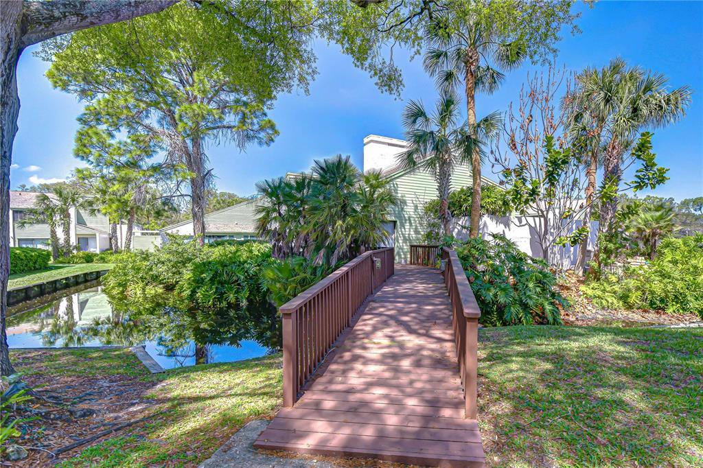 13402 Pinelake Way, Unit 202B Tampa, FL 33618 - Photo 40 of 42 a view of a garden with a bench