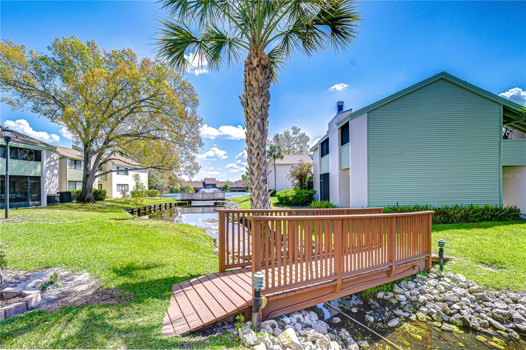 13402 Pinelake Way, Unit 202B Tampa, FL 33618 - Photo 42 of 42 a view of a house with backyard and a garden