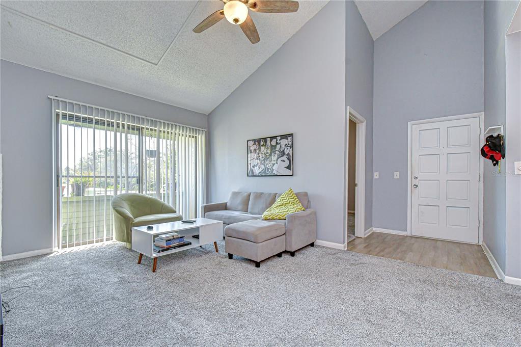 13402 Pinelake Way, Unit 202B Tampa, FL 33618 - Photo 6 of 42 a living room with furniture and a large window