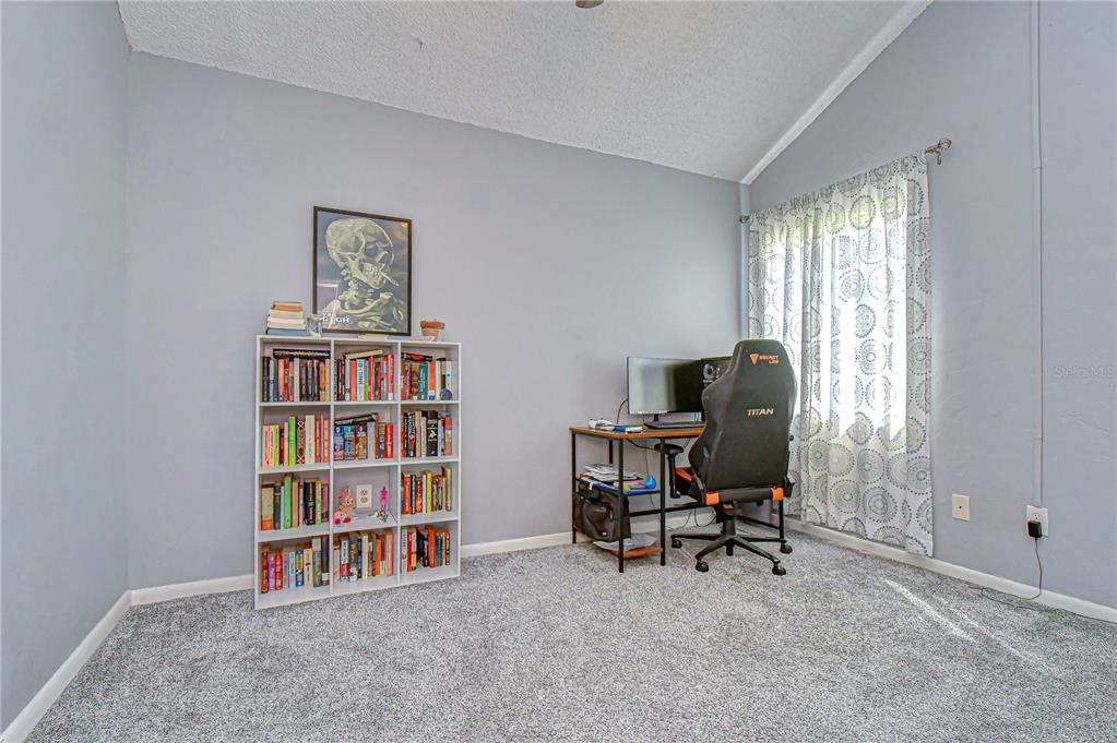 13402 Pinelake Way, Unit 202B Tampa, FL 33618 - Photo 7 of 42 a view of a workspace with furniture and a bookshelf