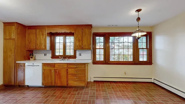 a kitchen with a sink cabinets and window