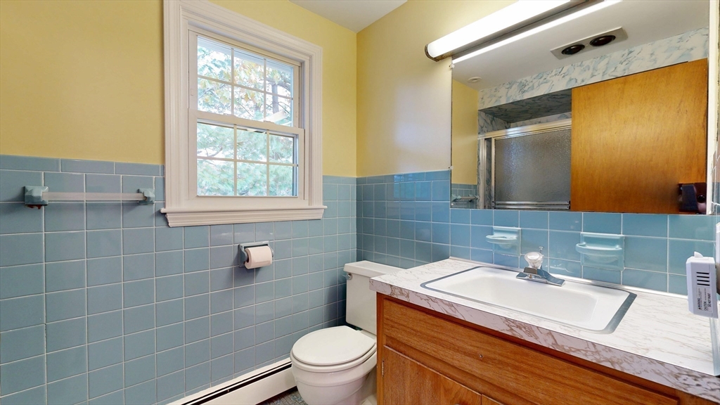 70 Old Nahant Road Wakefield, MA 01880 - Photo 29 of 42 a bathroom with a granite countertop sink a toilet and a mirror
