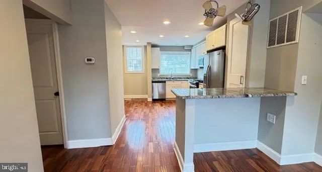 a view of a kitchen from the hallway