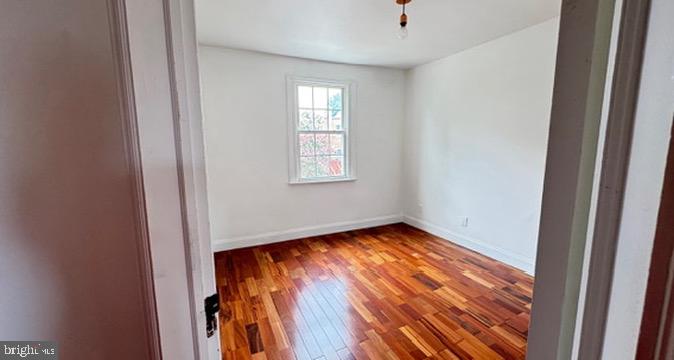 814 South Oak Street Arlington, VA 22204 - Photo 11 of 21 a view of an empty room with wooden floor and a window