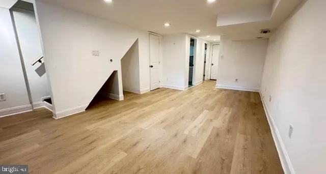 a view of an empty room with wooden floor