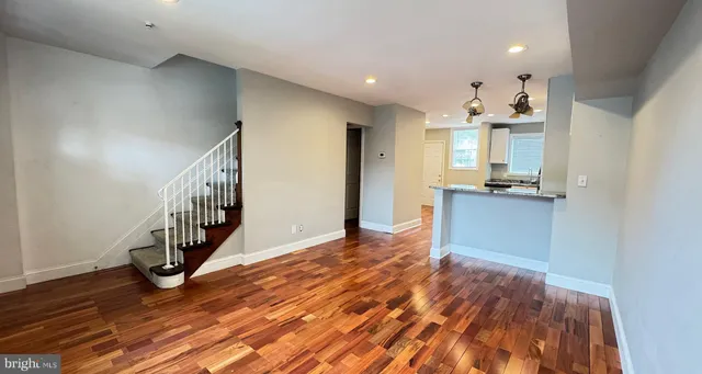 a view of a kitchen with wooden floor and a kitchen