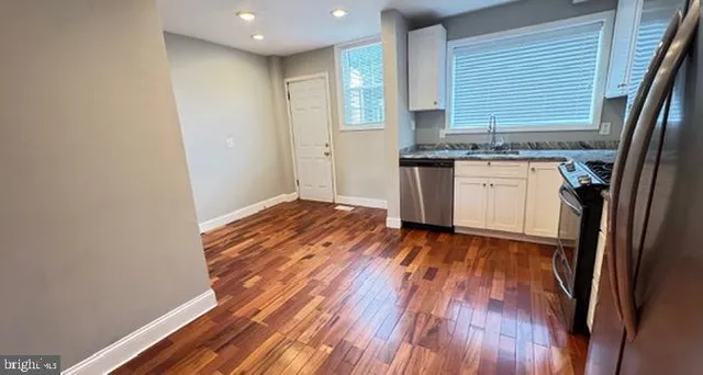 a kitchen with wooden floors and a sink