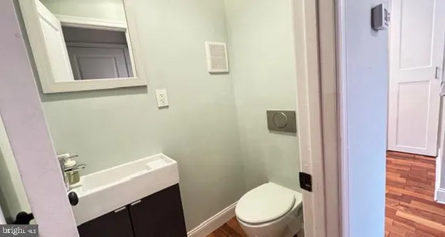 a white toilet sitting next to a bathroom sink