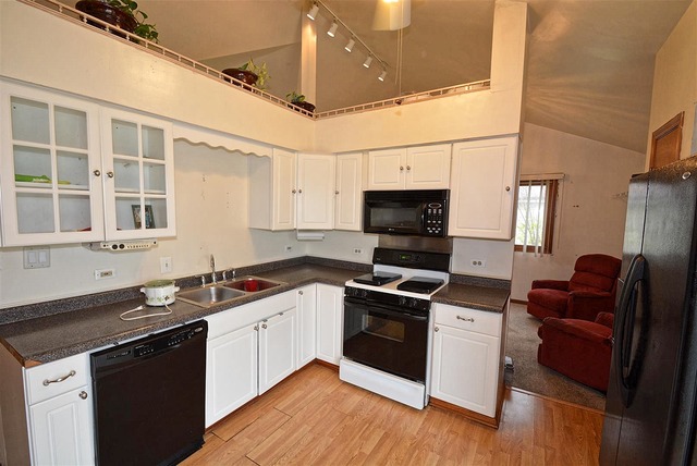 317 Wheatfield Road Matteson, IL 60443 - Photo 8 of 14 a kitchen with stainless steel appliances granite countertop a sink stove and refrigerator