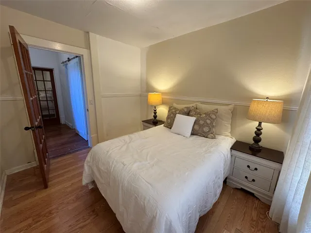 a bedroom with a bed and a large mirror