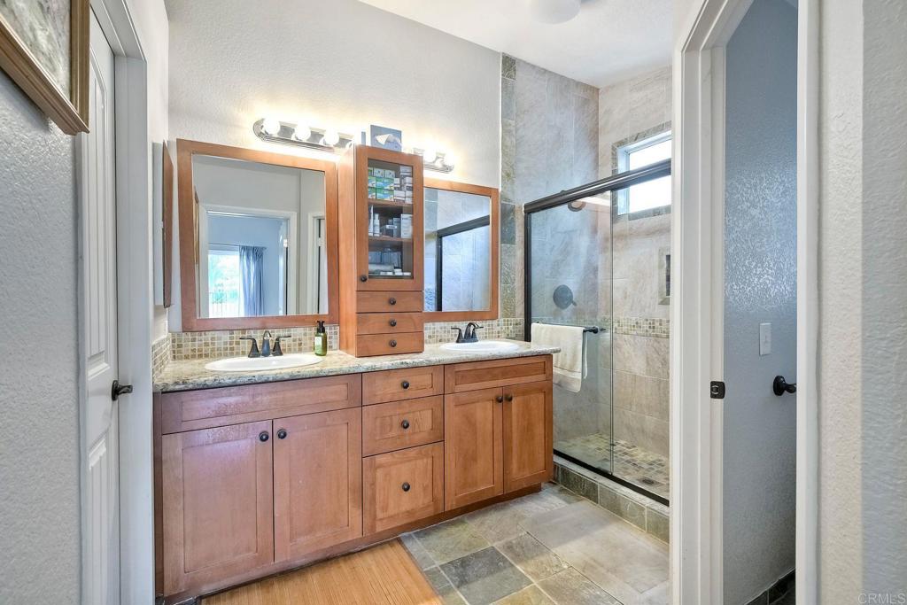 1208 Sunglow Drive Oceanside, CA 92056 - Photo 12 of 20 a spacious bathroom with a double vanity sink a mirror and a shower