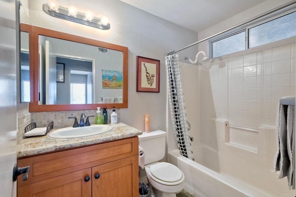 1208 Sunglow Drive Oceanside, CA 92056 - Photo 14 of 20 a bathroom with a granite countertop sink toilet and shower