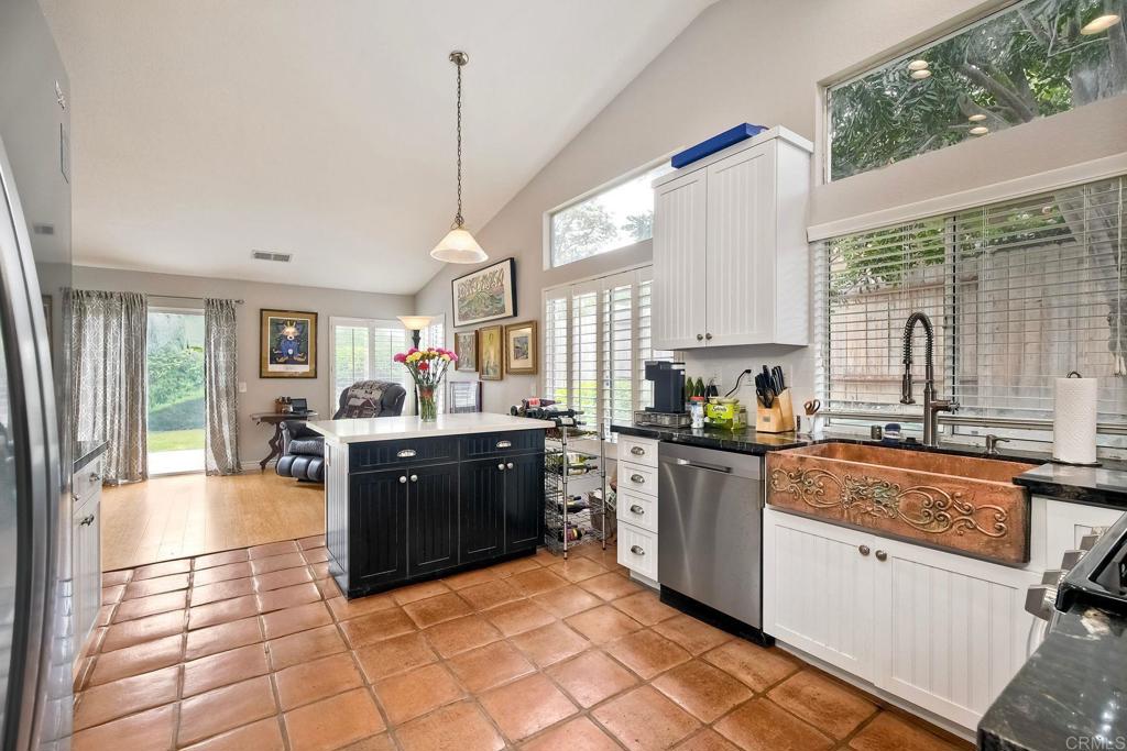 1208 Sunglow Drive Oceanside, CA 92056 - Photo 7 of 20 a large kitchen with kitchen island granite countertop a large counter top space a sink a counter space and stainless steel appliances