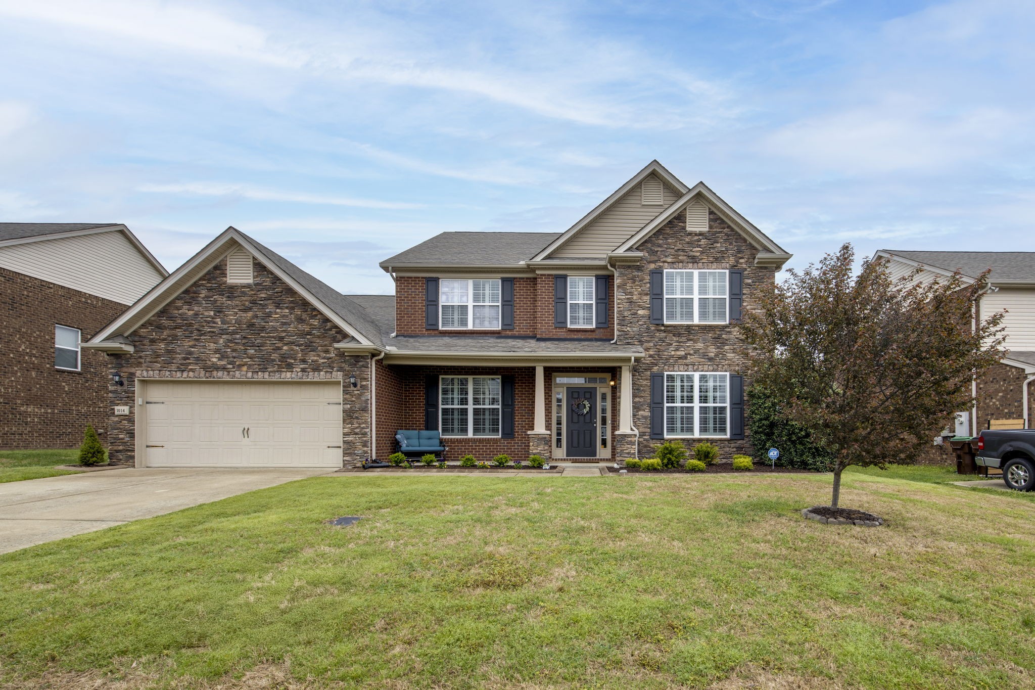 a front view of a house with a yard