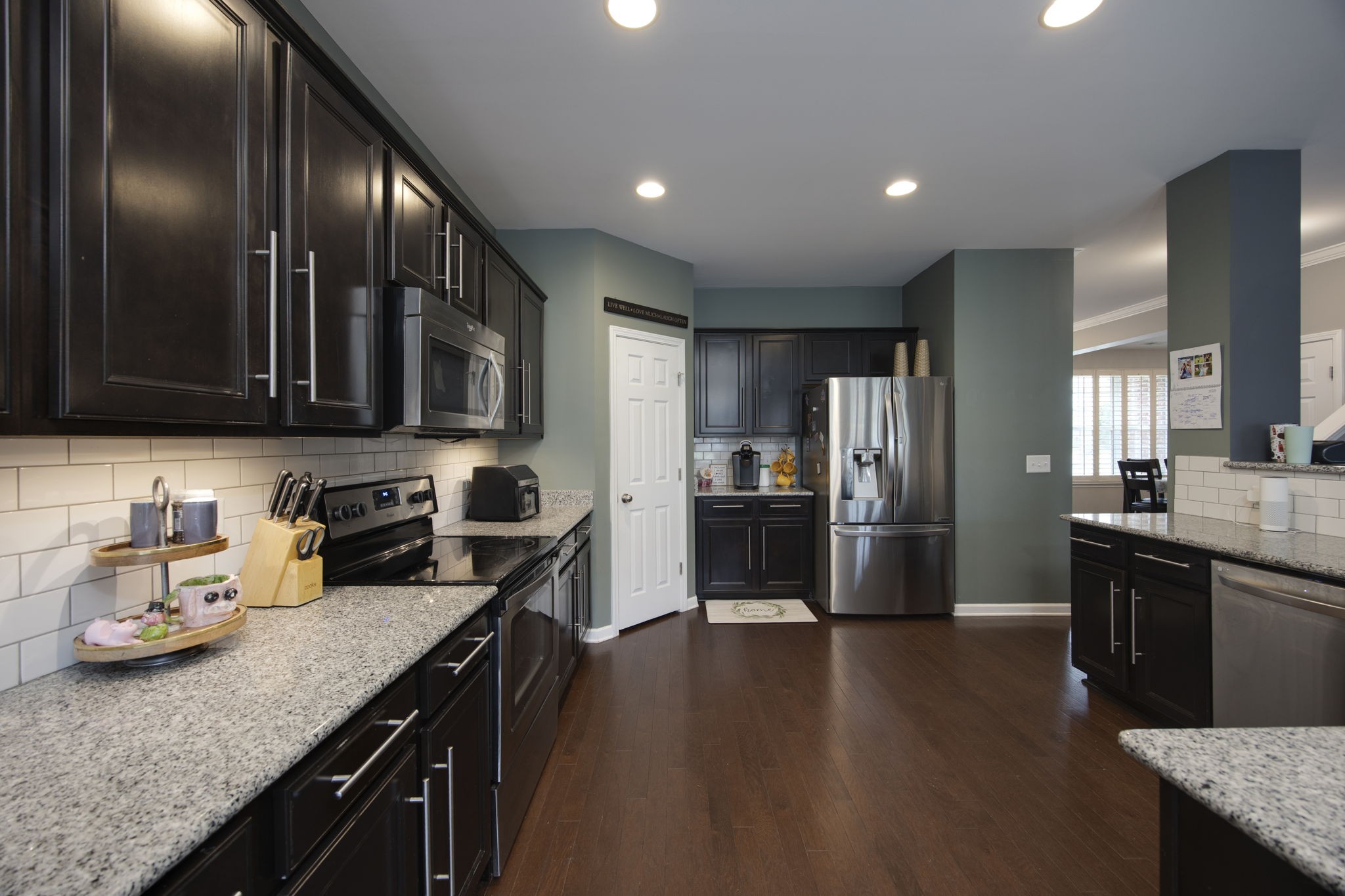 1014 Lacebark Lane Hendersonville, TN 37075 - Photo 22 of 69 a kitchen with stainless steel appliances granite countertop a sink wooden cabinets and stove top oven with wooden floor