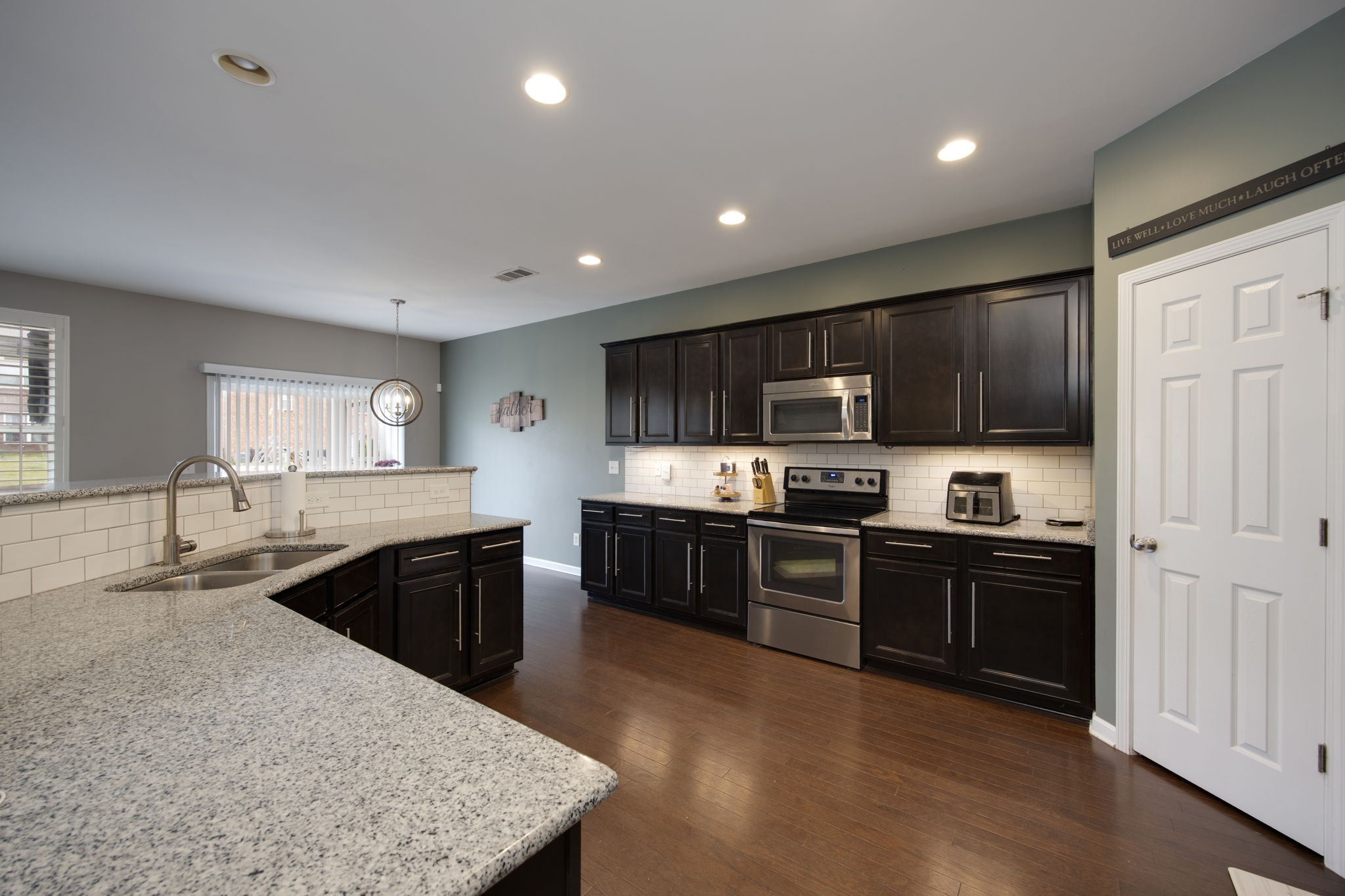1014 Lacebark Lane Hendersonville, TN 37075 - Photo 23 of 69 a large kitchen with stainless steel appliances granite countertop a stove top oven a sink dishwasher a dining table and chairs with wooden floor
