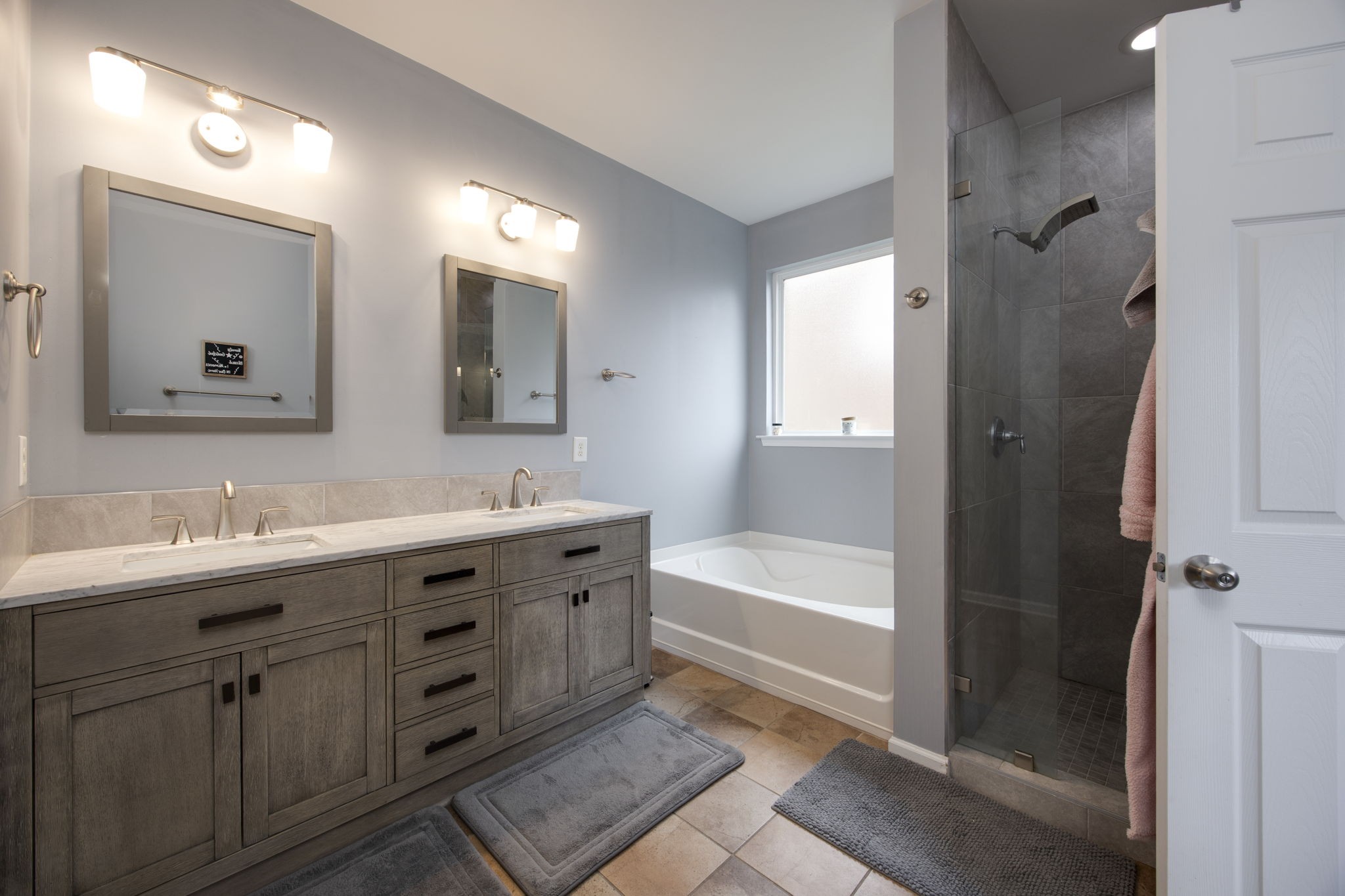 1014 Lacebark Lane Hendersonville, TN 37075 - Photo 34 of 69 a bathroom with a tub a double vanity sink and mirror