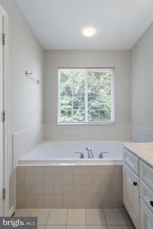 a bathroom with a bathtub and a window