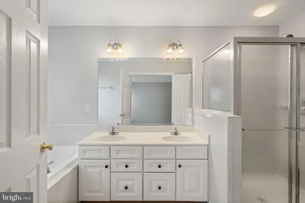 a bathroom with a sink double vanity and a mirror