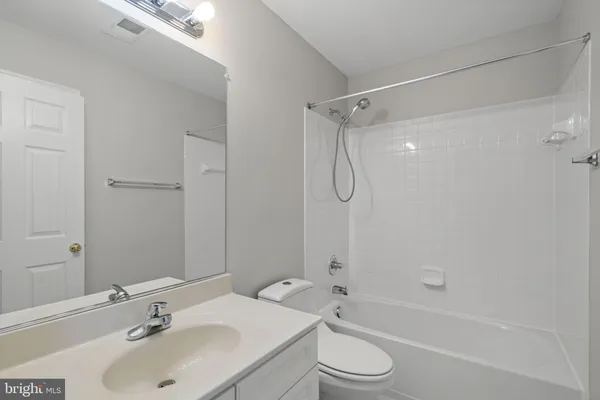 a bathroom with a sink toilet tub and shower