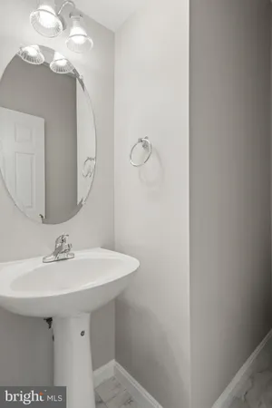 a bathroom with a sink a mirror and a light fixture