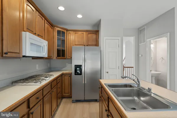 a kitchen that has a sink cabinets counter space and stainless steel appliances