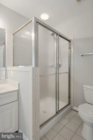 a bathroom with a shower a toilet and a sink