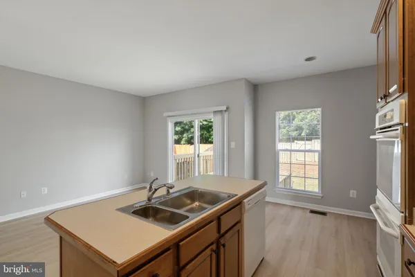a view of a kitchen that has a sink and a stove top oven