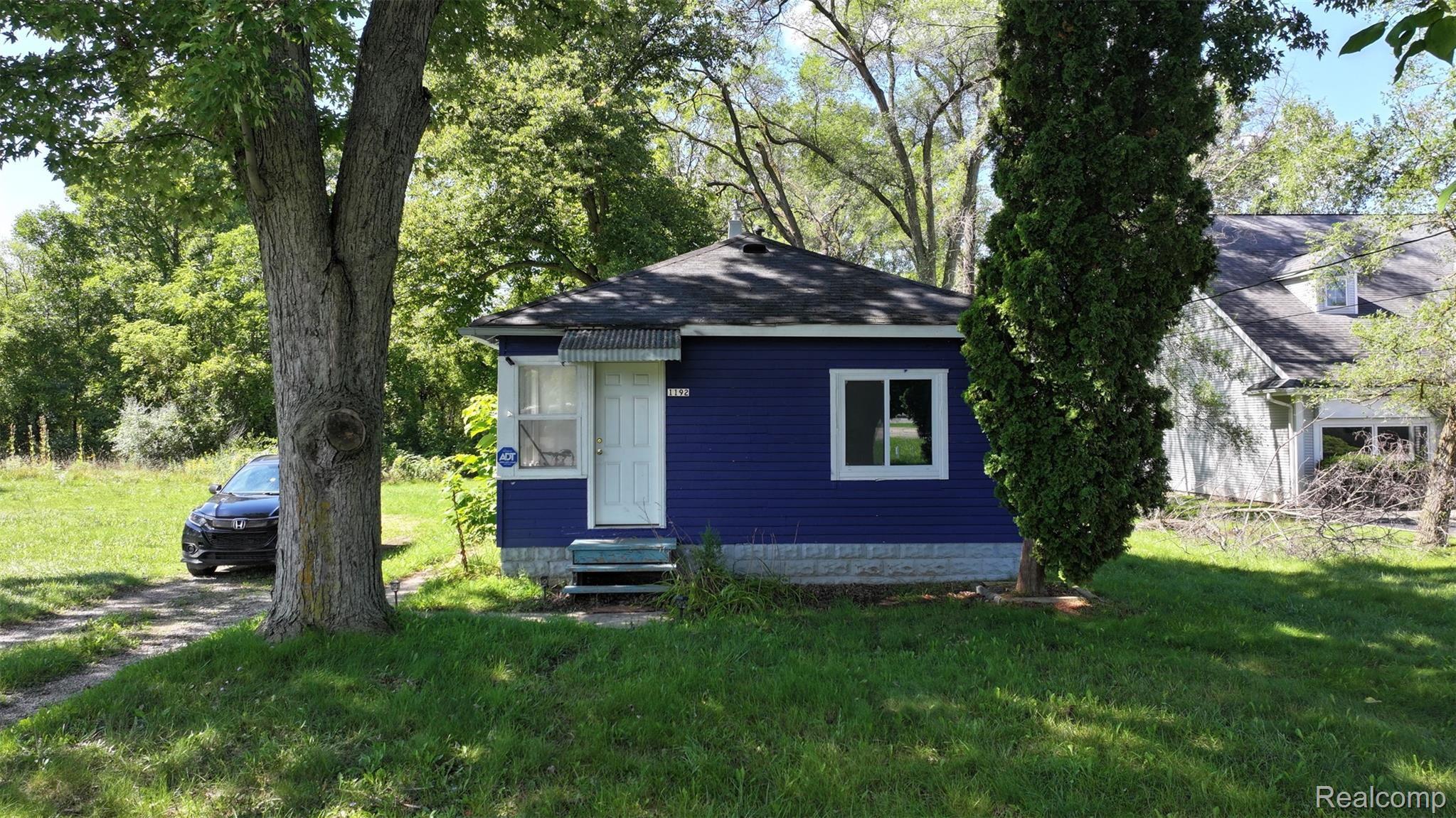 1220 Belsay Road Burton, MI 48509 - Photo 25 of 30 Blue siding exterior with white trim