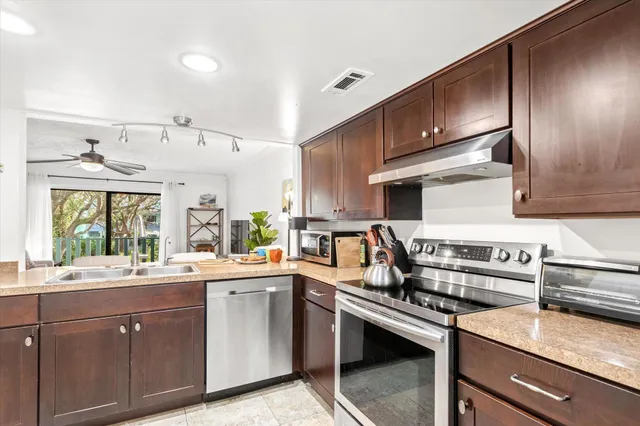 a kitchen with a sink stove and cabinets