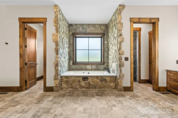 a bathroom with a tub shower and sink