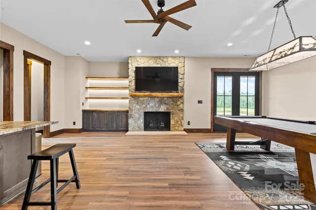 a living room with a fireplace furniture and a flat screen tv