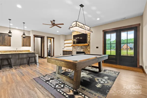 a living room with furniture a flat screen tv and a floor to ceiling window