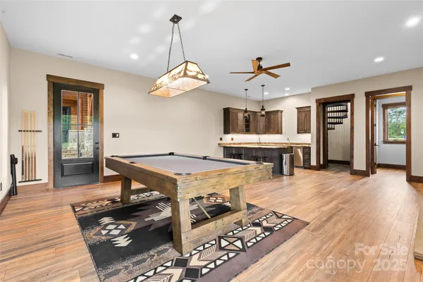 a living room with fireplace furniture and a wooden floor