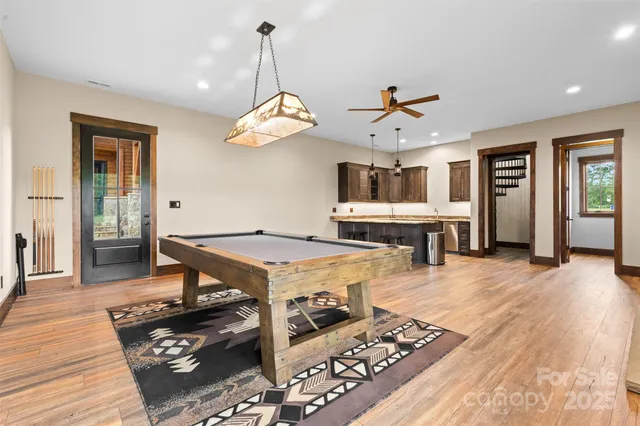 a living room with fireplace furniture and a wooden floor