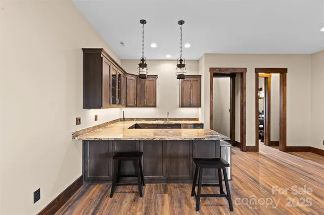 a view of a a dining room with furniture window and wooden floor