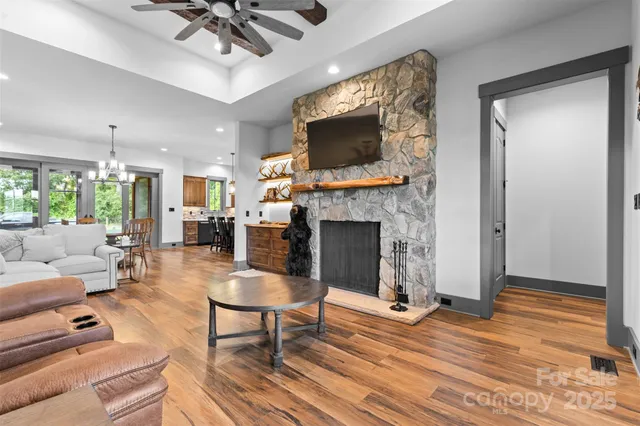 a living room with furniture a flat screen tv and a fireplace