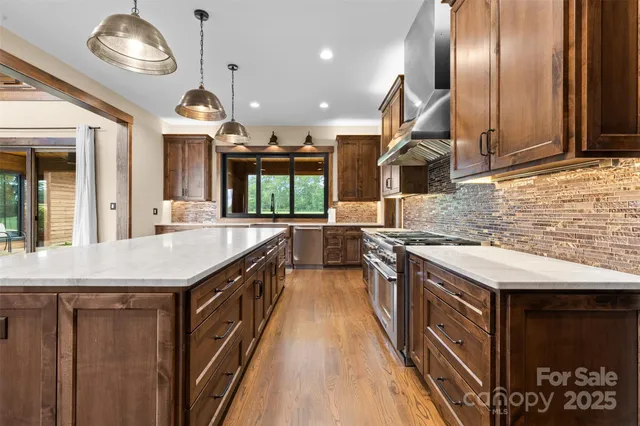 a kitchen with stainless steel appliances granite countertop counter space a sink and a refrigerator