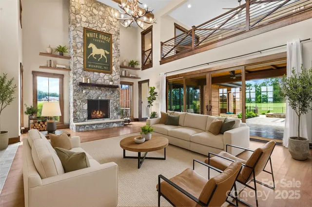 a living room with furniture a fireplace and a large window