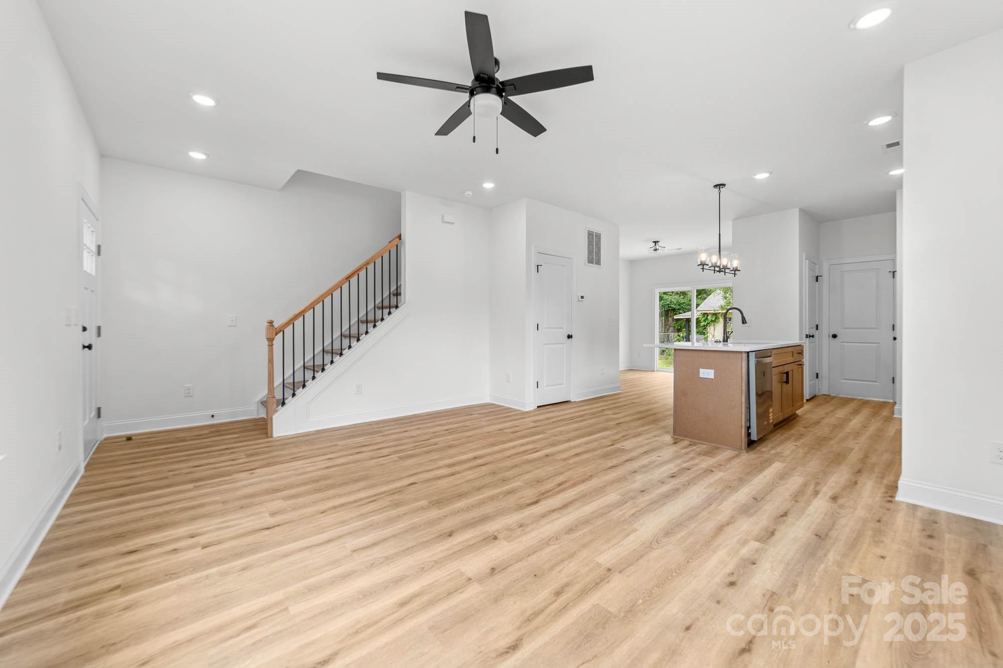 424 Airline Extension Shelby, NC 28150 - Photo 13 of 35 a view of kitchen and empty room with wooden floor