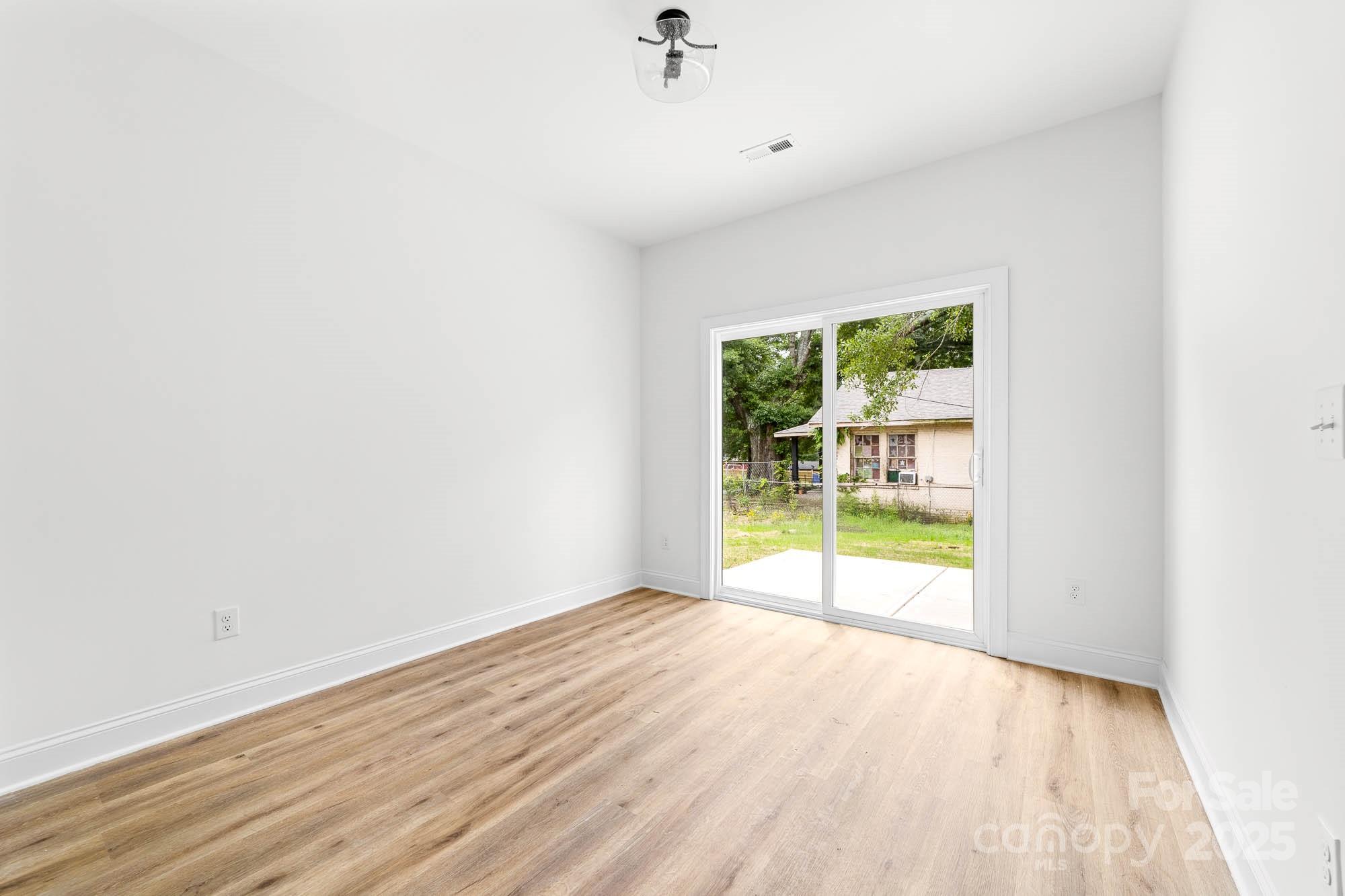 424 Airline Extension Shelby, NC 28150 - Photo 15 of 35 an empty room with wooden floor and windows