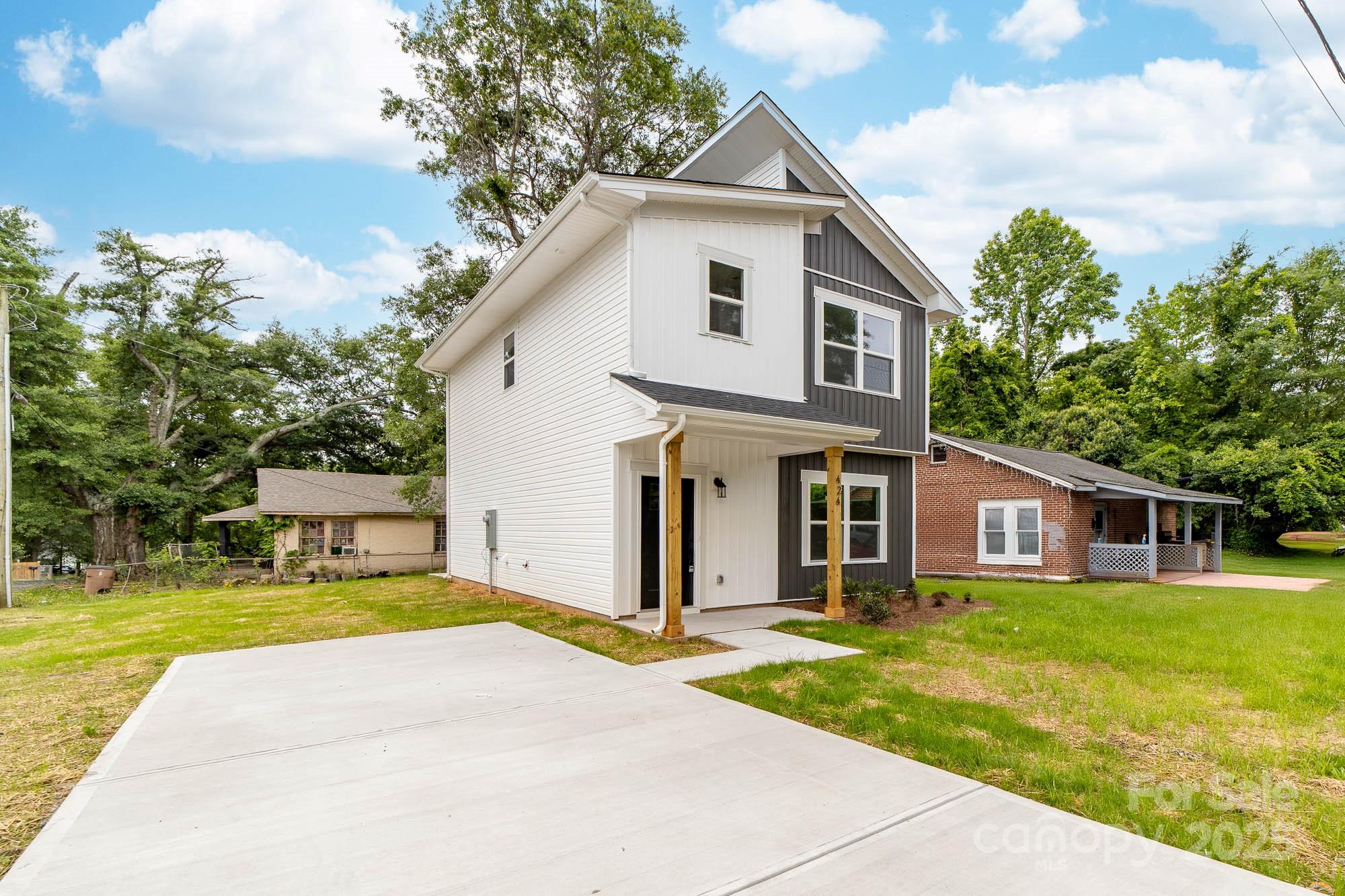 424 Airline Extension Shelby, NC 28150 - Photo 2 of 35 a front view of a house with a garden and yard