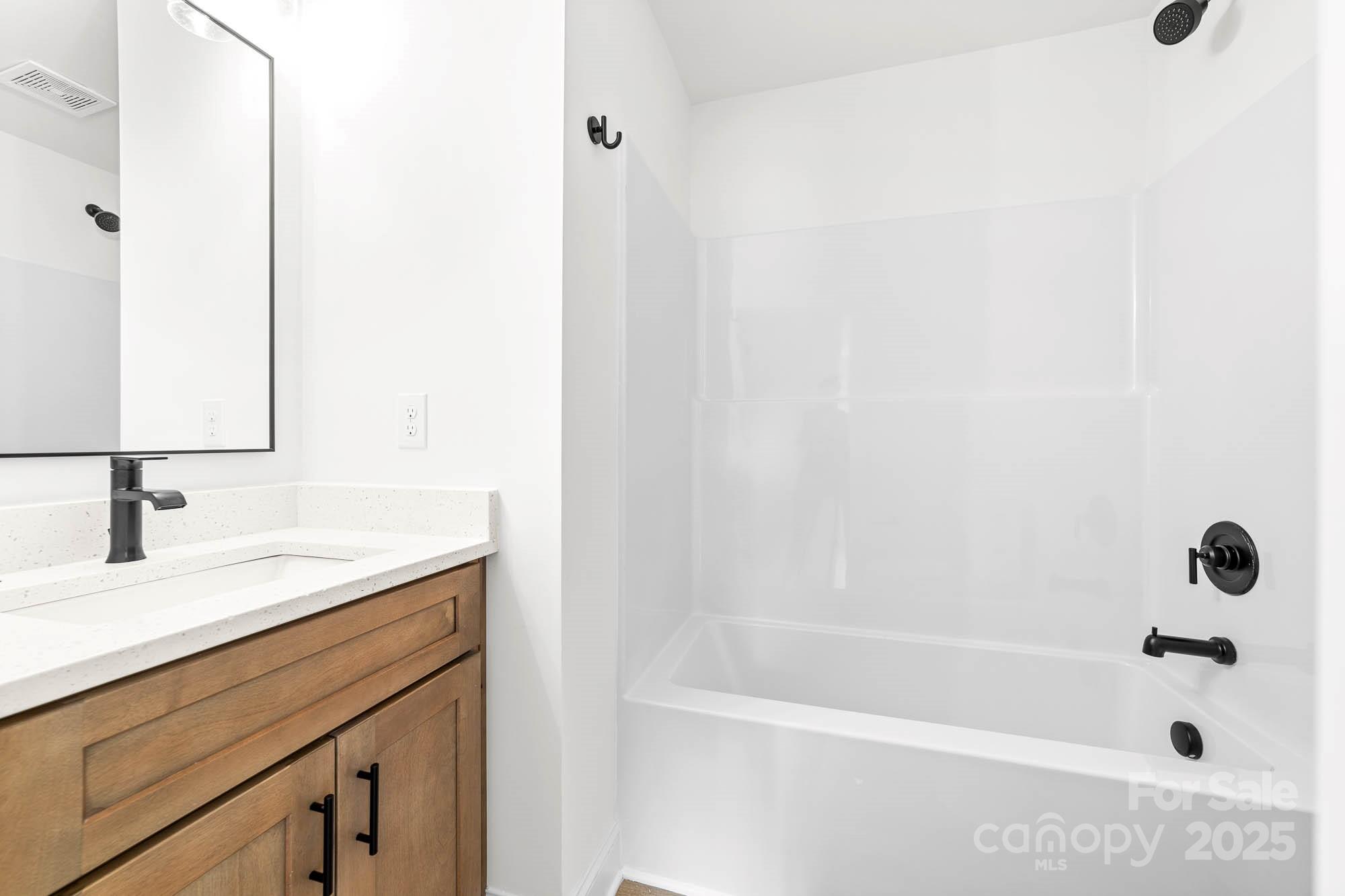 424 Airline Extension Shelby, NC 28150 - Photo 23 of 35 a bathroom with a bathtub sink vanity and mirror