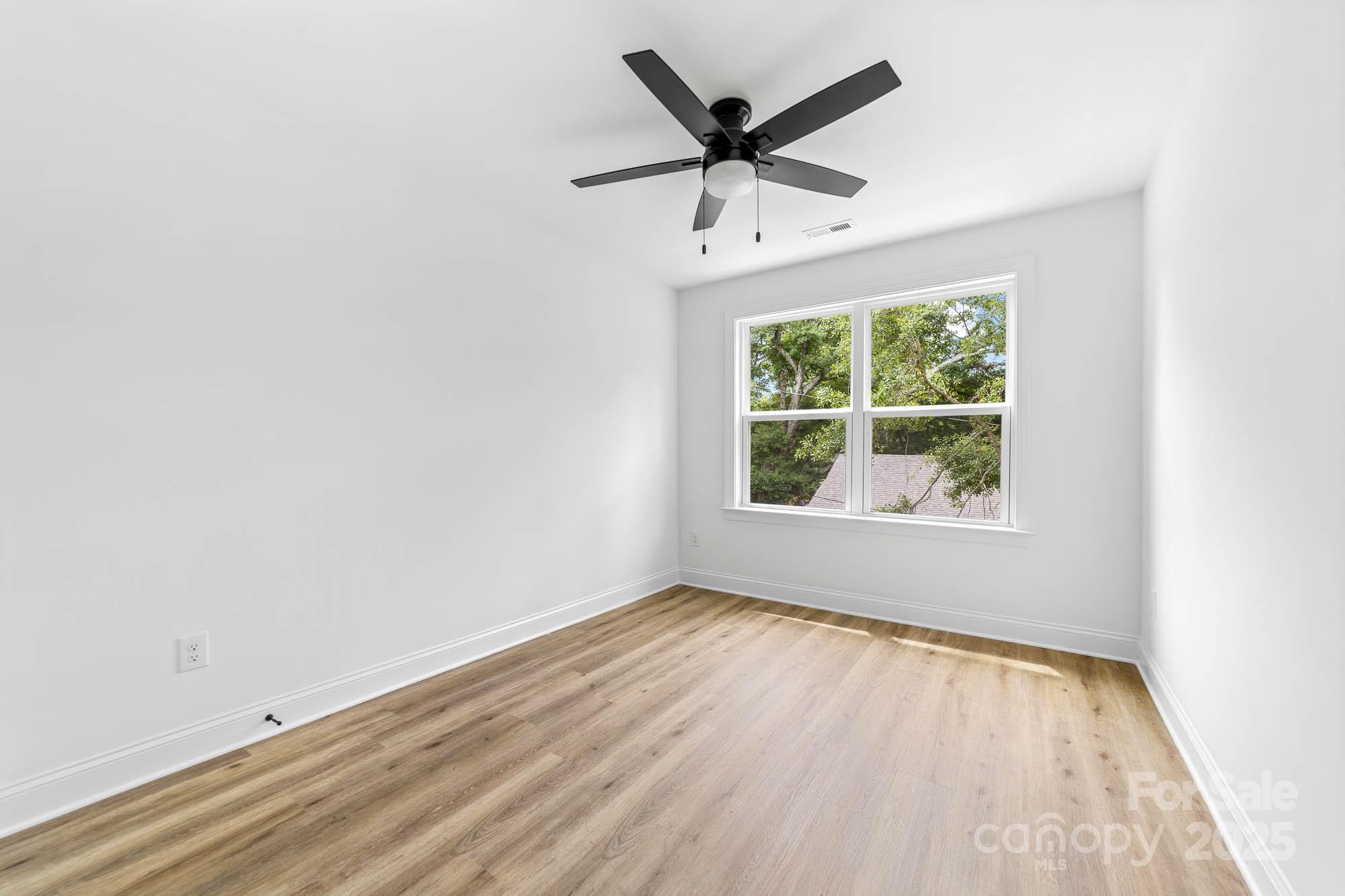 424 Airline Extension Shelby, NC 28150 - Photo 25 of 35 an empty room with wooden floor and windows