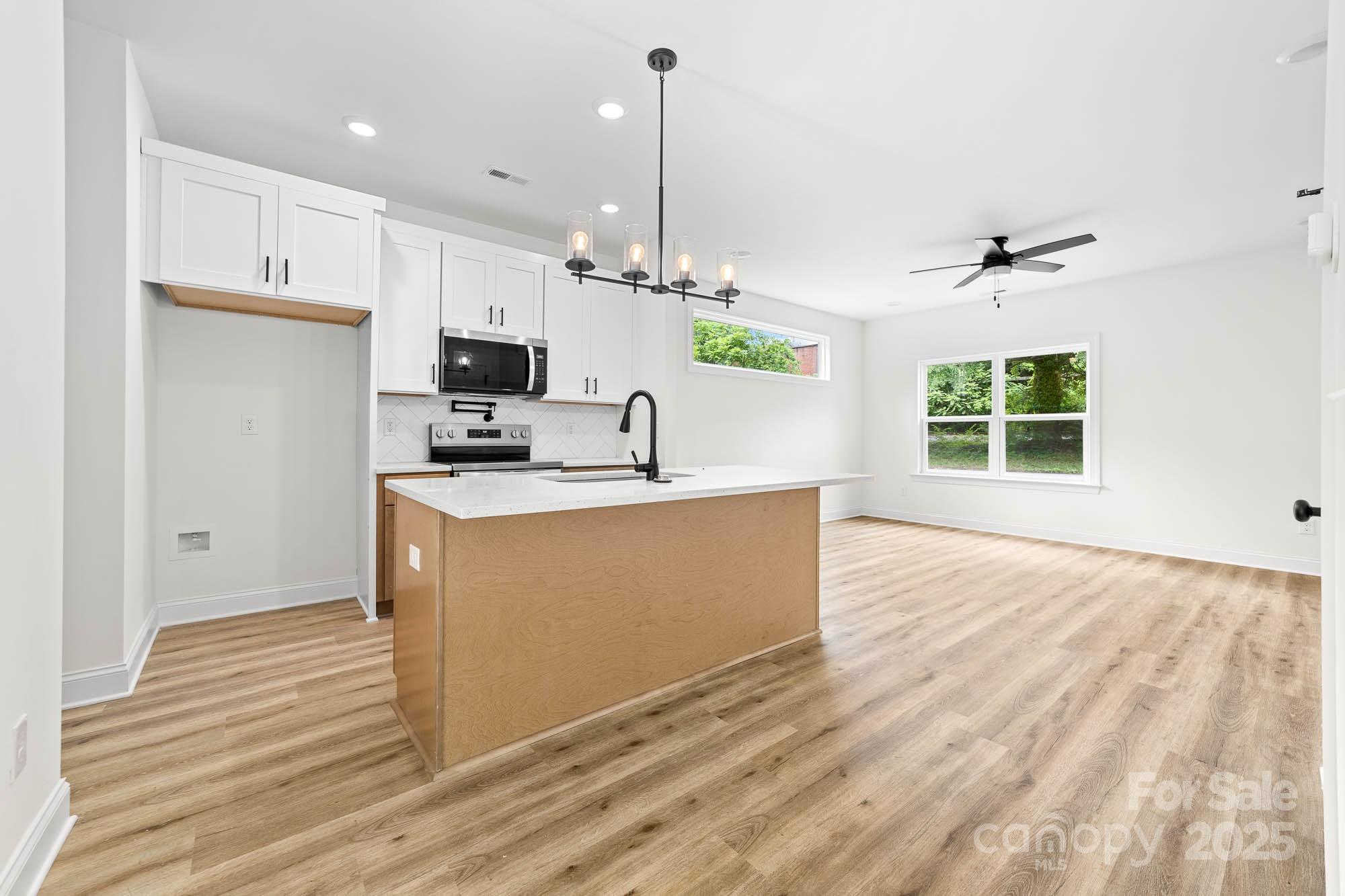 424 Airline Extension Shelby, NC 28150 - Photo 7 of 35 a kitchen with stainless steel appliances granite countertop a stove a sink and a white refrigerator
